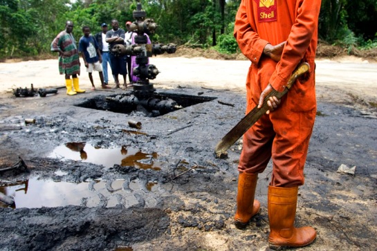 Workers subcontracted by Shell Oil Company clean up an oil spill from an abandoned Shell Petroleum Development Company well in Oloibiri, Niger Delta. Wellhead 14 was closed in 1977 but has been leaking for years, and in June of 2004 it finally released an oil spill of over 20,000 barrels of crude oil.